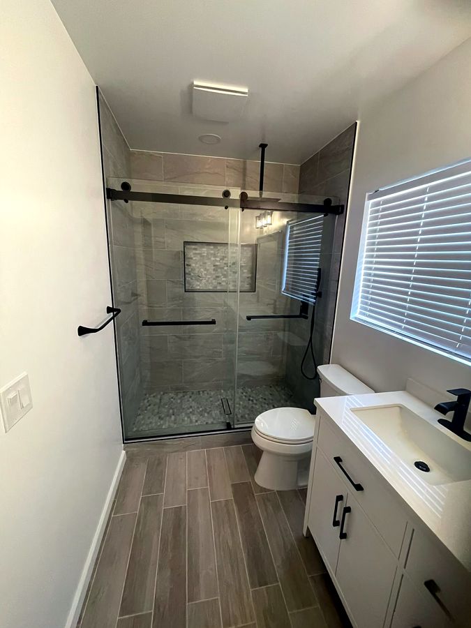 Bathroom with frameless sliding glass shower and modern vanity