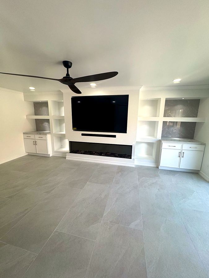 Built-in media wall with floating shelves and cabinet storage